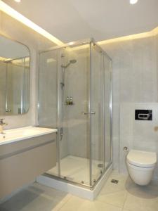 a bathroom with a shower and a toilet and a sink at Istanbul Park Hotel in Tuzla