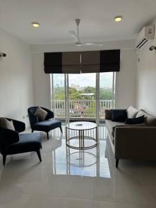 a living room with two couches and a table at Luxury 3 bed flat in Colombo 7 in Colombo