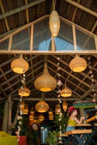 a group of wicker lights hanging from a ceiling at Backpack Beach Hostel & Reggae Bar in Galle