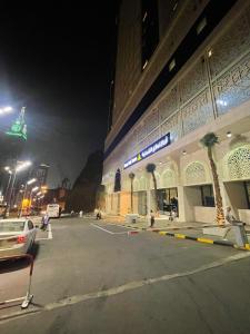 een parkeerplaats voor een gebouw 's nachts bij Nawazi Towers Hotel in Mekka
