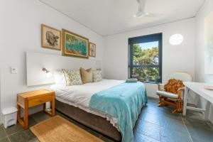 a bedroom with a bed and a desk and a window at 10 Dash Apartment, Dunkirk in Sheffield Beach +47 photos