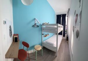 a bedroom with a bunk bed and two chairs at East Harlem Hostel in New York