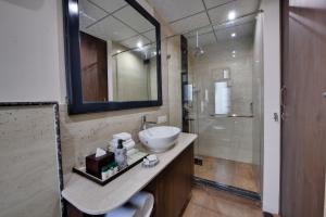 a bathroom with a sink and a shower at The Fern Habitat, Jaipur in Jaipur