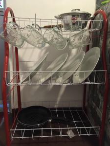 a rack with plates and pans in a kitchen at Sky Family Villa Ahangama in Ahangama