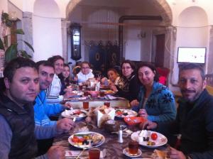 a group of people sitting at a table eating food at Demirkapi Konak Hotel in Safranbolu