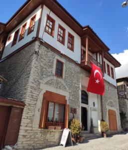 a building with a flag in front of it at Demirkapi Konak Hotel in Safranbolu