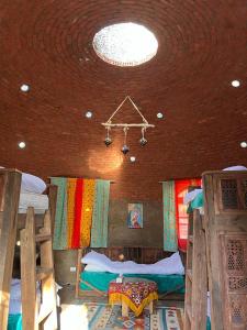 a room with two beds and a ceiling at Nassimah in Giza