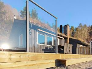 a log cabin with a large window on the roof at 4 person holiday home in ydegard in Torvikbukt