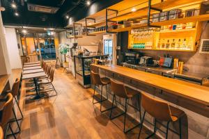 a bar in a restaurant with stools at Tokyo Guesthouse HIVE in Tokyo
