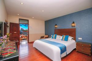 a bedroom with a large bed with a blue wall at Wenjun Courtyard Hotel ---5 mins walk from Tonghuimen metro station, near Tianfu square, close by culture park and Sichuan opera house, English speaking service, local tours in Chengdu