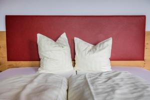 A bed or beds in a room at Berggasthof Hochzeigerhaus