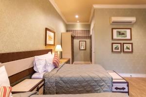 een hotelkamer met een bed en een bank bij Rancho Charnvee Resort & Country Club Khaoyai in Pak Chong