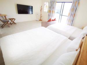 Letto o letti in una camera di 全新電梯民宿 日富一日