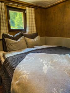 a large bed in a room with a window at Chalet Wildalpen (in Ruhelage & mit Wellness) in Wildalpen