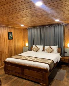 a bedroom with a large bed in a room at Pine Forest Retreat in Kurseong