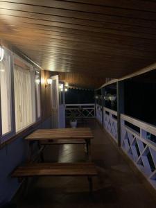 a wooden table in a room with a bench at Pine Forest Retreat in Kurseong