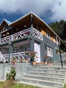 a house with stairs in front of it at Pine Forest Retreat in Kurseong