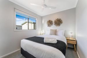 a white bedroom with a large bed and a window at BIG4 Tasman Holiday Parks - Bendigo in Bendigo