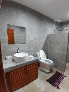 a bathroom with a sink and a toilet at Roland Villa in Koh Samui 