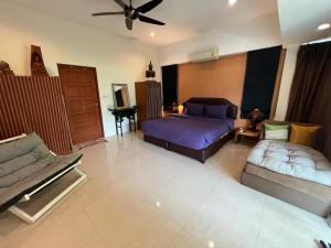 a bedroom with two beds and a couch at Roland Villa in Koh Samui 
