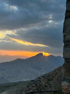 a view of a mountain with the sunset in the background at The View in Al Ḩamrāʼ