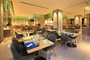 un comedor con mesas y sillas y un restaurante en Hilton Garden Inn Xi'an High-Tech Zone en Xi'an