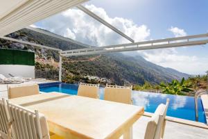 a dining room with a table and a view of a mountain at infinity mountain in Kalkan