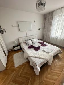 a bedroom with a large bed and a wooden floor at central place in Braşov