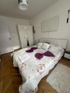 a bedroom with a large bed with purple robes on it at central place in Braşov