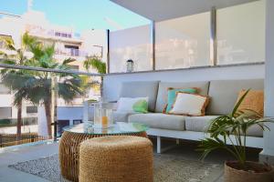 a living room with a couch and a table at Aguacate Beach Apartamentos Playa Granada in Motril