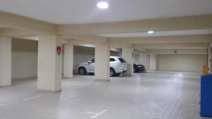 a parking garage with a white car parked in it at SEA BREEZE HOLIDAYS HOME in Colombo