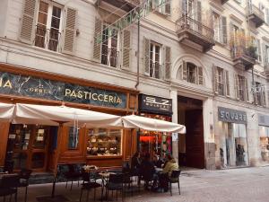 a group of people sitting at a table outside a restaurant at Lagrange 34 in Turin
