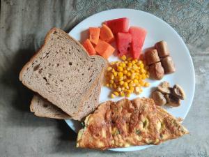 a plate of breakfast food with toast and vegetables at Holiday Home near Swayambhunath Stupa in Kathmandu