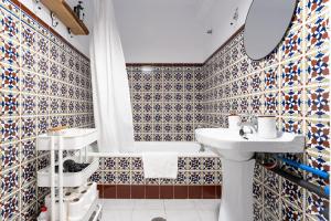 a bathroom with a toilet and a sink and a tub at La Cueva in Mijas