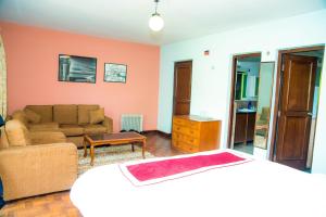 a living room with a bed and a couch at Holiday Home near Swayambhunath Stupa in Kathmandu