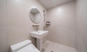 a white bathroom with a sink and a mirror at Annk Hotel Daejeon Daeheung in Daejeon