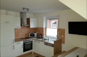 a small kitchen with a sink and a microwave at Zimmervermietung Aras in Paderborn