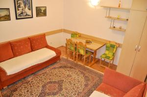 a living room with a couch and a table at Apartment Evropa in Zlatibor