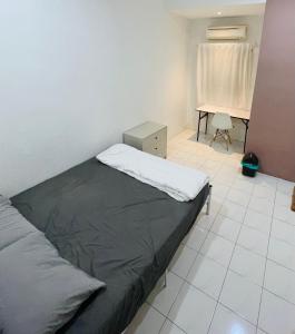 a bedroom with a bed and a desk in it at haus_22 in Bukit Mertajam