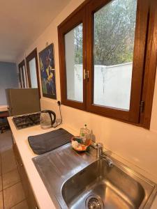 a kitchen counter with a sink and a window at Maison de charme 95m2, 4 chambres in Saint-Denis