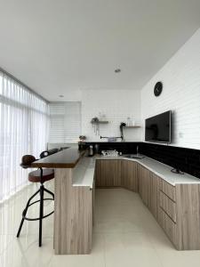 a kitchen with a large island with a counter and a sink at Valle Verde Villas in Bandung