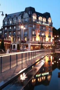 a hotel in front of a building at night at Hotel Moderne in Arras