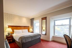 a bedroom with a large bed and a window at West Cork Hotel in Skibbereen