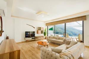 a living room with a couch and a table at infinity mountain in Kalkan
