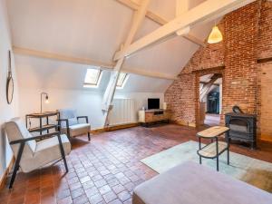 an attic living room with a brick wall at Nice apartment on UNESCO World Heritage Site Wortel Kolonie 