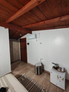 an attic room with wooden ceilings and a wooden floor at Dar Barka in Kebili