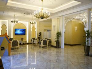 a lobby of a hotel with a chandelier at Al Anvar Halal Hotel by HotelPro group in Tashkent