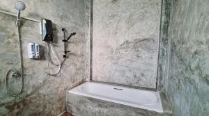 a bathroom with a shower and a bath tub at Blessing Pua in Ban Lao