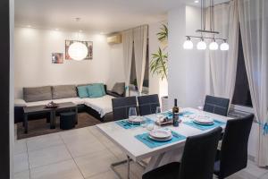 a dining room and living room with a table and chairs at Apartment MATEA in Kobarid
