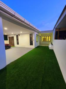 a room with a green lawn in a house at Kota Kinabalu family Home in Kota Kinabalu